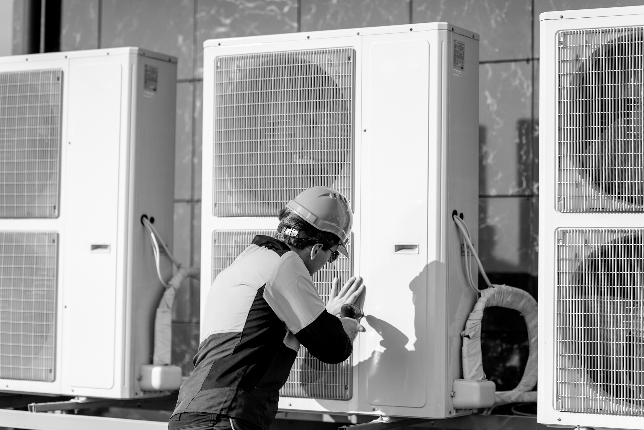 Workman Installing Outdoor Unit of the Air Conditioner